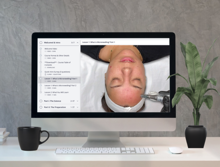 Computer screen displaying a video of a microneedling tutorial on a woman with a plant and mug on a desk.
